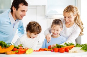Happy family preparing meal together in the kitchen.